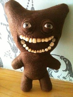 a brown stuffed animal with big eyes and teeth