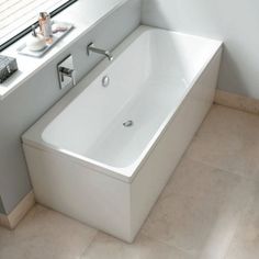 a white bath tub sitting next to a window