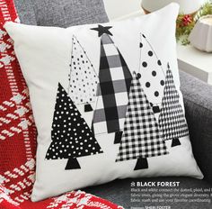 a black and white christmas tree pillow on a couch