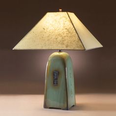 a table lamp that is sitting on top of a table next to a light bulb