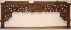 an ornate wooden shelf with carvings on it