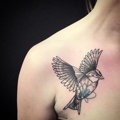 a woman with a bird tattoo on her chest