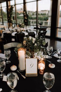 the table is set with candles and place settings for guests to sit down at it