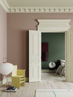 an open door leading to a bedroom with pink walls and white trim on the doors