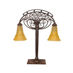 an iron and glass table lamp with three bell shades