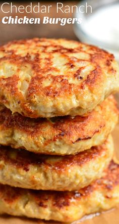 three crab cakes stacked on top of each other with the words chedda ranch chicken burgers