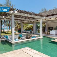 an outdoor living area next to a swimming pool