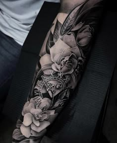 a man with a clock and flowers tattoo on his arm