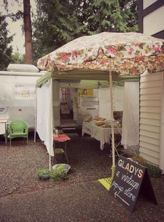 a tent that has some food on it and is next to a sign with the word glad's