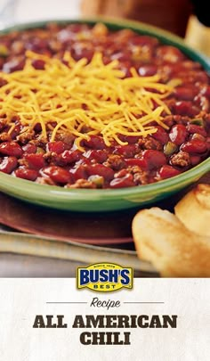 an ad for bush's chili with cheese on top and bread in the background