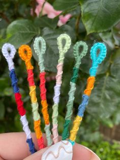 there is a small group of crocheted toothbrushes in someone's hand