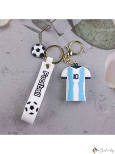 a keychain with a soccer jersey on it and a bottle opener attached to it