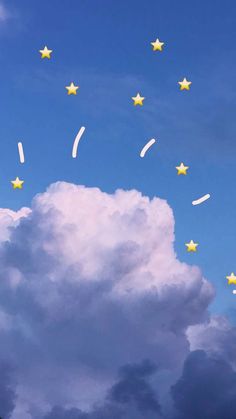 the sky is filled with yellow stars and white puffy clouds are in the foreground