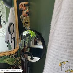 a bathroom with a mirror and wallpaper on the wall next to a towel rack