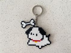 a cross stitch keychain with a cartoon character on it