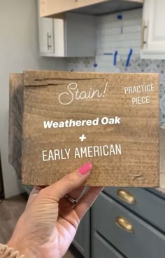 someone holding up a sign that says, stain weathered oak and early american on it