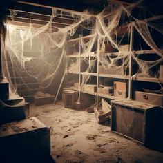 an abandoned room with spider webs hanging from the ceiling