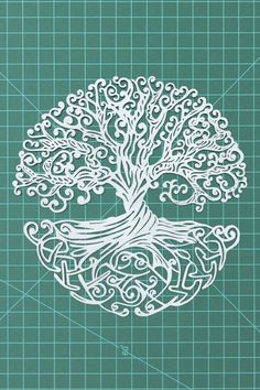 a paper cut out of a tree with swirly branches and leaves on it's sides