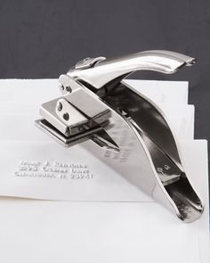 a silver stapler sitting on top of an envelope