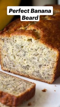 a loaf of banana bread sitting on top of a white plate next to a banana