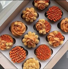 cupcakes with orange frosting in a box