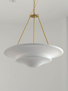 a light fixture hanging from the ceiling in a room with white walls and flooring