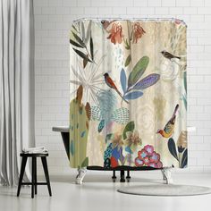 a shower curtain with birds and flowers on it in a white room next to two stools