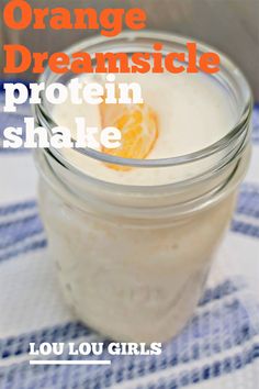 an orange drink in a mason jar with the words, orange dreamsice protein shake