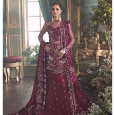 Described On Site As A Wine Color Net Shirt Is Composed In Embroidery & Embellished Floral & Leafy Stalks Of Lillies, Pensys & Irises. A Heavy Jewelled Neckline Is Set In Pearls & Crystals To Make A Statement With Wine Colored Satin Sequins Border In Feathery & Floral Details On Hem. Same Colored Bling Dupatta In Embroidery & Purple Organza Border On Sleeves. Includes Net Shirt With Slip Raw Silk Trouser Net Dupatta Worn Once & Dry Cleaned Will Fit Size Small-Medium Measurements Can Be Provided Republic Womenswear, Net Shirt, Silk Trousers, Net Dupatta, Wine Color, Irises, Wedding Collection, Wine Colored, Raw Silk