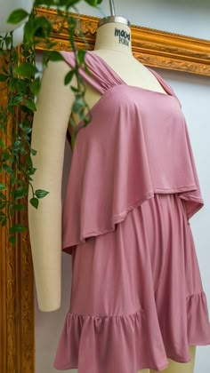 a mannequin wearing a pink dress with ruffles