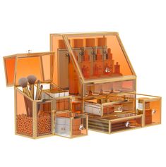 an assortment of orange and silver items in a wooden box with mirrors on the sides