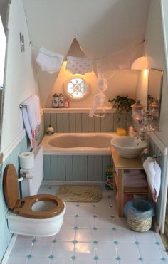 a small bathroom with a toilet, sink and bathtub in the middle of it