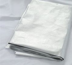 three white sheets folded on top of each other