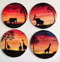 four painted coasters depicting giraffes and elephants at sunset with birds flying in the sky