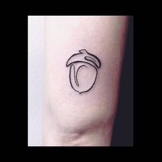 a black and white photo of a small tattoo on the right arm, with a line drawing of an apple