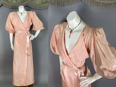 Beautiful vintage 1940s balloon sleeve robe in peachy pink pastel rayon taffeta.  A lovely lightweight glamour dressing gown with shirring at the shoulders creating the puff sleeves and full dramatic sleeves.  The robe is a wrap style with inner snap and outer snap.  There is satin ribbon tie belt.  The belt is not original, but it is vintage and matches well.  I added it from my belt box.  A color like baby blue or seafoam green would be really pretty with it too!  The robe is unlined and has elastic at the three-quarter or elbow length sleeves (depending on how far you push them up). LABELS: None remain.   MEASUREMENTS of the garment: Modern size *estimate*:  has ties to adjust but probably best for xs to s.  Bust:  36" to 38" surplice style V neck Waist:  28" and snaps could  be moved t Dramatic Sleeves, Vintage 40s, Pink Pastel, Womens Robes, Dressing Gown, Nightgowns, Peachy Pink, Ribbon Tie, Vintage Clothes