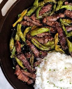 steak, rice and asparagus in a skillet