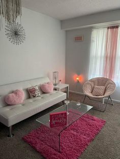 a living room filled with furniture and pink rugs