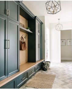 an entryway with built in cabinets and rugs on the floor next to it