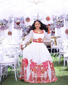 a woman in a white and red dress is dancing