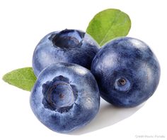 three blueberries with green leaves on a white background