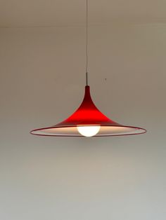 a red light hanging from the ceiling in a room