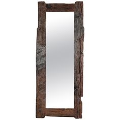 a wooden mirror sitting on top of a white wall