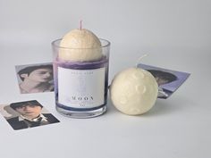 a candle and some pictures on a white table with a photo next to it that says wooooy