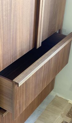 a close up of a wooden cabinet door with drawers and doors on the bottom half