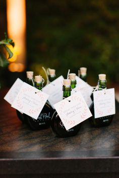 small bottles with labels on them sitting on a table