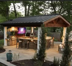 an outdoor kitchen and dining area is shown