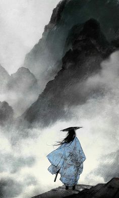 a woman standing on top of a mountain under a cloudy sky