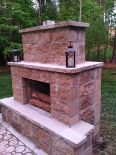 an outdoor fireplace with a lantern on top