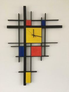 a clock that is on the side of a wall with squares and lines around it